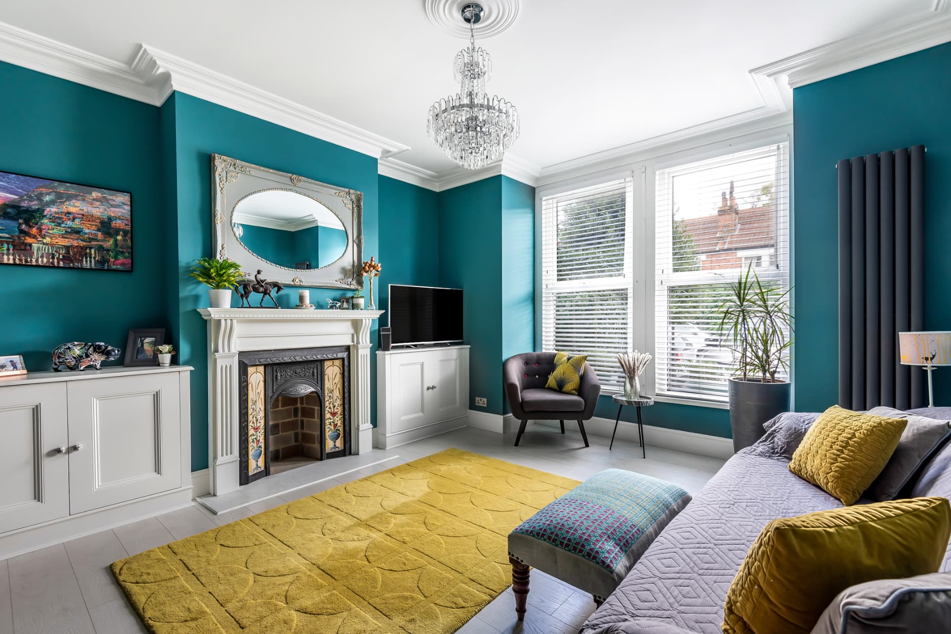 Edwardian living room with teal walls and a mustard rug