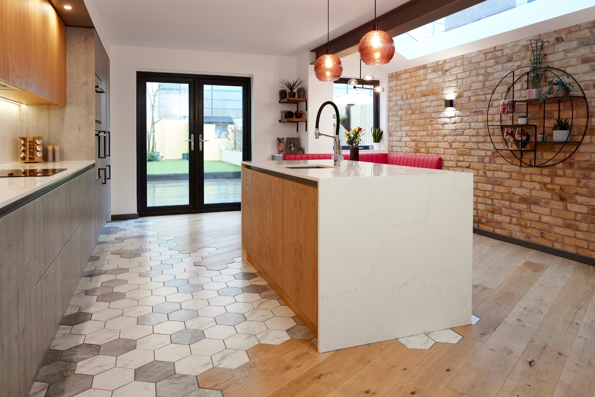 Long view of the side return kitchen showing hexagon tiles blending into timber flooring